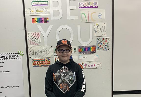 Parkside School 5th Grader Owen Kunkel poses for a photo wearing a hat in support of Caps for a Cure.