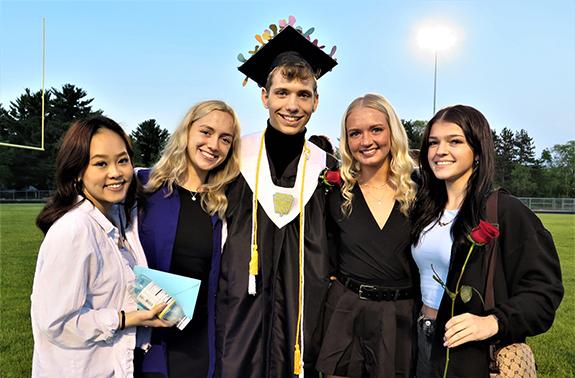 Tri-County High School graduate Steve Kuhn was all smiles when his friends gathered around him for a Waushara Argus photo following the Tri-County High School evening, outdoor graduation ceremony on May 27.  Pictured are:  Ning Lee, Plover, Nelia Stauss, Stevens Point, Kuhn, Sadie Kole, Plover, and Marlee Warner, Plover. Kuhn plans to attend the University of Wisconsin-Stout in the fall. See the Waushara Argus print edition for more photos.
