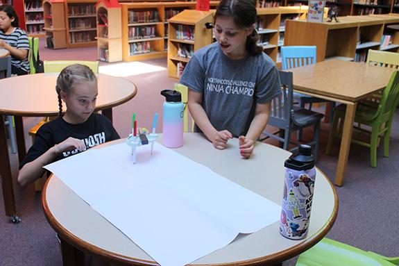 Gwyn Gruszka and Arley Vaughan watch as the Drawbot they built together starts to move during their Camp Parkside Makerspace Class with Mrs. Kintigh.
