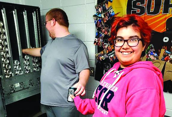 Andrew Taubitz and Andreanna McElroy work together to restock the Wautoma High School vending machine in the teacher’s lounge. This is one of the many jobs students enrolled in the 18-21 Program do on a regular basis.