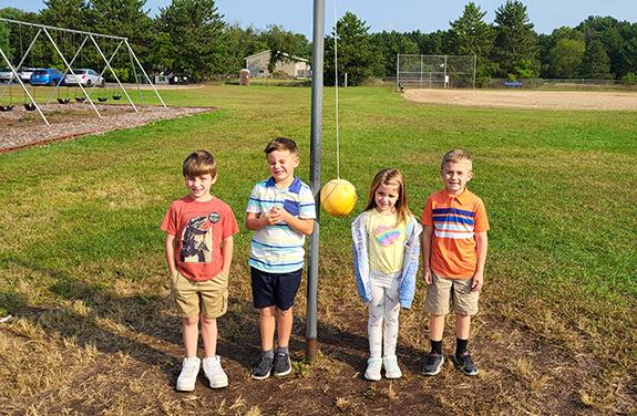 Wild Rose Elementary students Christian Wagner, Dane Johnston, Makena Schubert, and Lukas Luchini with some of the outdoor equipment.