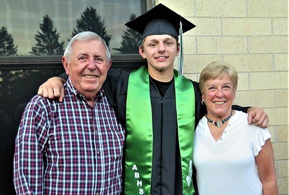 Almond-Bancroft High School graduate Devyn Feltz was all smiles after the graduation ceremony on May 26.  His uncle and aunt, David and Linda Rosenthal, Racine, posed for a picture with him following the ceremony.
