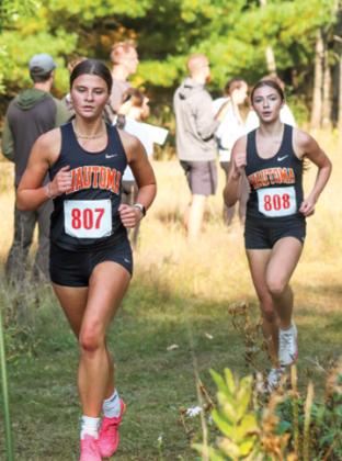 Wautoma/Wild Rose runners Mya Bahr and Brooklyn Bruning race closely at Camp Lucerne.