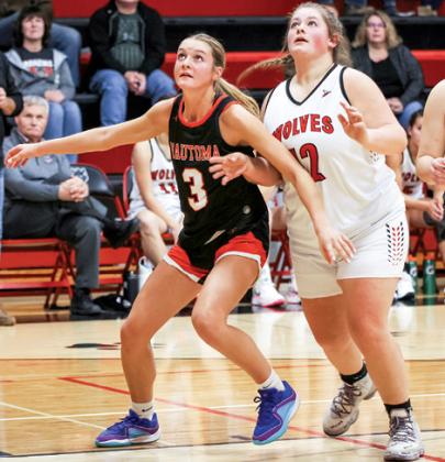 Wautoma’s Montana Groskreutz keeps Manawa’s Isabella Ferg out of the lane as both players look to grab a rebound.