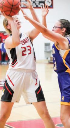 Tri-County’s Courtney Bauck stands up against Adyson Hull on Marion defense while looking for an open teammate.