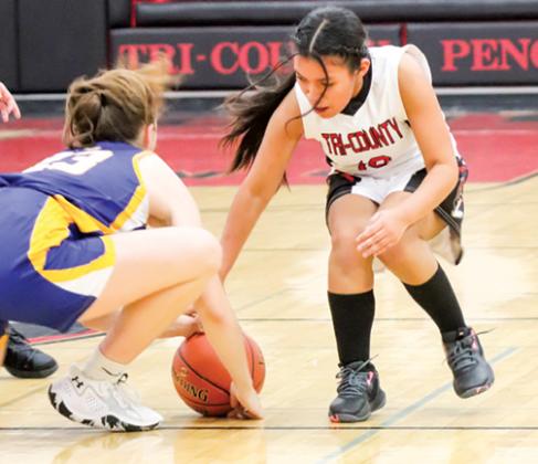 Tri-County’s Areli Herrera tries to scoop the ball away from a Lady Mustang during the Nov. 28 matchup at Tri-County High School.
