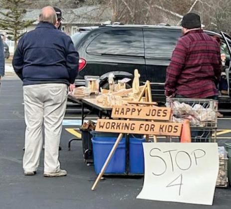 Volunteers loaded holiday food and gifts into vehicles during distribution, including popular wooden toys created by the Happy Joes men’s group.