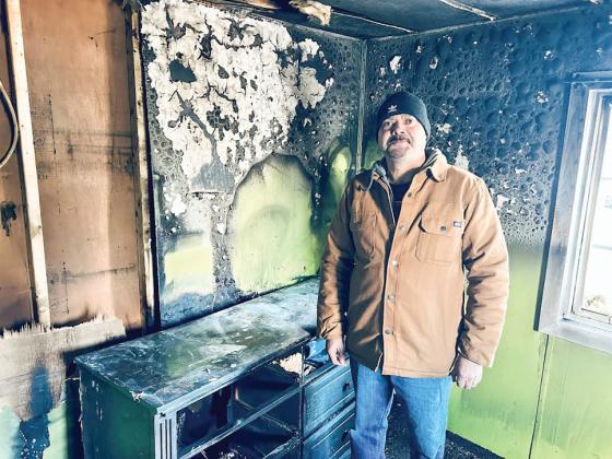 Rogelio Sanchez is pictured showing officers the fire damage in his bedroom. 