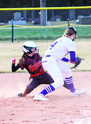 Wautoma’s Liv Weiss slides back into first base safely while Wild Rose’s Addison Smykal attempts to tap her out. 