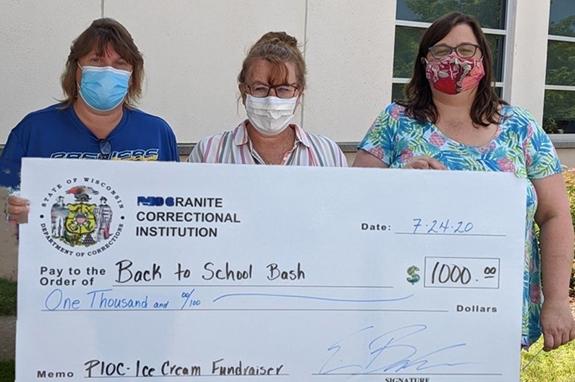 Redgranite Correctional Institution Financial Specialist Advanced, Tracey Schroeder and Deputy Warden Program Assistant Michelle Sonnentag with Back to School Bash Committee Chair Angie Konieczki display a $1,000 check to be used for Back to School Bash.