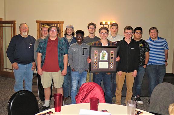 This group of participants in “Authentic Manhood—33 The Series” gathered for a photo during their celebration dinner at Christianos Pizza on Nov. 16: (back): Group leader Ray Berglund, Andrew Palm, Mitchell and Alex Greenham, Matthew Marks, Joel Martinez, and group leader Malachi Marks; (front): Michael Marks, Moses Lyne, Josh Borud, and Jordan Daye.  The young men and their fathers participated in the program, which involved meeting for 18 Sunday evenings to see and discuss two videos each evening.  Berglu