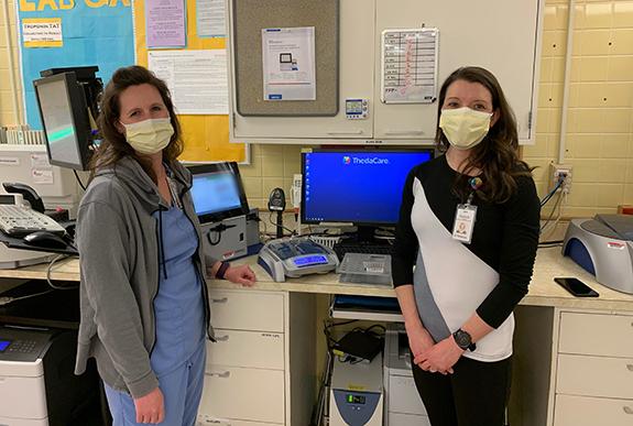 Rebecca Schultz, Blood Bank Key Operator at ThedaCare Medical Center-Wild Rose and Elizabeth Kujawa, Laboratory Manager at ThedaCare Medical Center-Wild Rose, help install the DG Reader Net semi-automated analyzer, used to facilitate pre-transfusion blood type compatibility testing.