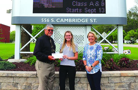 Jeff Kasuboski presents the first ever Jeffrey Kasuboski Foundation Scholarship to Juleanna C. Johnson with Chris Brown, manager of the Wautoma Regional Center of Fox Valley Technical College. 