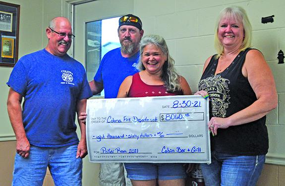 Al Bock, owner of the Cabin Bar and Grill, Coloma, Bill Beers, Paula Beers, and Krista Basse (left) all from the Cabin Bar and Grill presented a check for $8,060 raised through the 2021 Poker Run ride. This year due to weather they had fewer riders, but still managed to receive many generous donations from the community. Al Bock presented the check to the Coloma Fire Chief Nate Sigourney on Aug. 30. The fire department also presented a plaque to the Cabin Bar and Grill for all of the support throughout the 