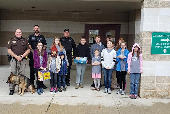 On Oct. 28, the Blazing Stars 4-H club presented both the Waushara County Sheriff’s Department and the Wautoma Fire Department thank you cards and treats to show their appreciation for our local first responders on First Responders Day. Pictured at the Sheriff’s Office are Sheriff Wally Zuelke, Deputy Matt Elliot, Deputy Lance Nelson, McKenzie Heise, Savannah Heise, Macy Carlton, Ada Carlton, Zander Carlton, Davin Gunderson, Innish Wall, Finnian Wall, Esca Wall, Isolde Wall, Eiley Wall, MaKayla Verstegen, a