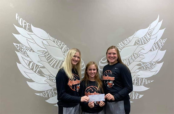 Wautoma’s senior volleyball members Brianna Handel, Bailey Blader-Lucht, and Jalyn Piechowski hand delivered a donation to Peaceful Purpose Inc. from money they raised during their Oct. 12 volleyball match.