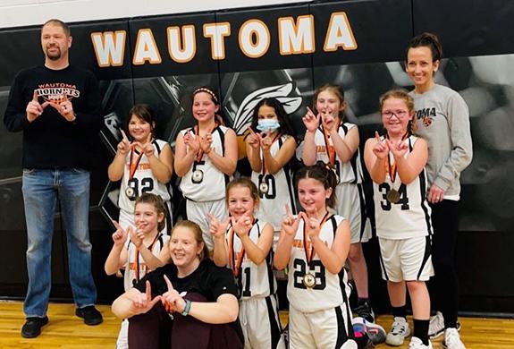 The third grade girls basketball team competed on Feb. 5 at the Wautoma Backboard Club Tournament. The team was 3-0, taking first place. (back): Coach Joey Rosin, Fynlie Korman, Arley Vaughan, Serenity Piper, Emmersyn Pietkauskis, Lexi Rosin, and Coach Marsha Rosin;  (front): Kylie Putskey, Assistant Coach: Mel Putskey, Brooklyn Boettcher and Katelyn Bushweiler. (not pictured): Gwyn Gruszka.
