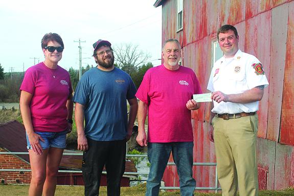The Wild Rose Classic Car Show representatives have been busy distributing funds to various organizations. Pictured are Beth Cutts, Brent Jenks, and Al Jenks presenting checks from the last two years to Al Luchini of the Wild Rose Area Fire Department.
