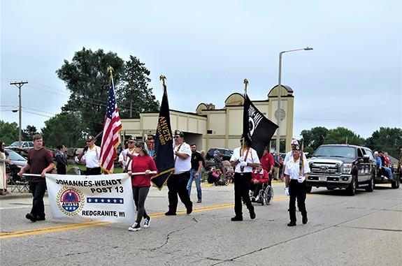 The Redgranite Johannes-Wendt Post 13 Amvets honor guard lead the Redgranite Labor Day parade on Sept. 5. A truck behind them carried Redgranite and state Amvets officials.  The parade theme was “Fest with the Best.”  