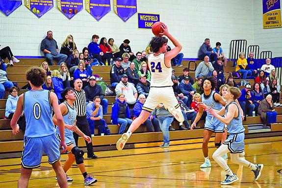 Senior Pioneer Mitchel Meinke is airborne in an attempt to get the ball down the court during the Jan. 12 conference matchup against the Wisconsin Dells Chiefs. 