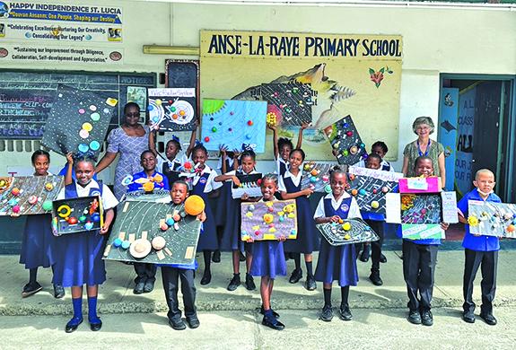 The third grade class and their teacher, Miss Joseph, displaying their science projects with Mary Smaby at Anse La Raye Primary School.