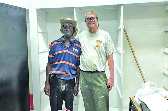 Mike Smaby is pictured working with the school caretaker, Mr. Jonah.
