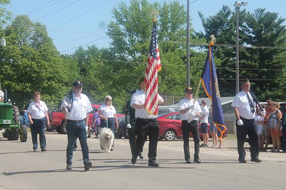 The Wild Rose American Legion Daniel Dopp Post 370 Color Guard closely followed the village squad car to lead the Memorial Day parade on May 29.