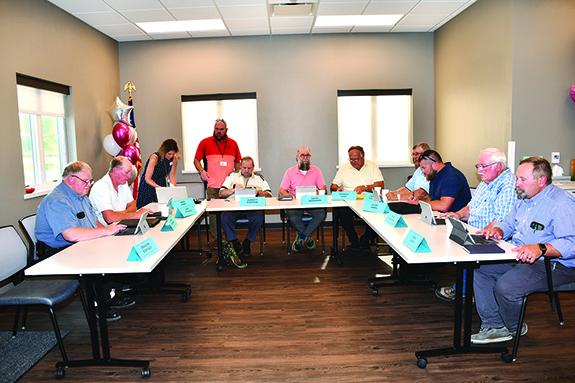 The board gets set for the June meeting at the Poy Sippi Center following a ribbon cutting ceremony.  The photo includes: Mark Piechowski, Bart Peterson, Megan Kapp, County Clerk, Barry West, IT, Everett Eckstein, David Bosshard, Pat King, Bob Wedell, Jesse Urban, Mark Kerschner, and John Jarvis, Chair.  (Not pictured county board members Mike Kapp and Brandon Bonfiglio.)