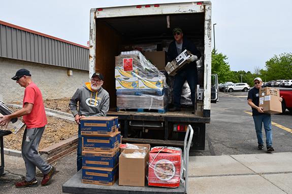 The Wautoma Kiwanis Team unloading 5,000 pounds of food for the Hornet Market.