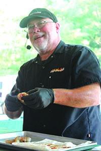 Chef Jeff Igel of Fox Valley Technical College started wrapping shrimp with bacon during an Aug. 3 demonstration at Evergreen Campsites and Resort, Wild Rose. 	