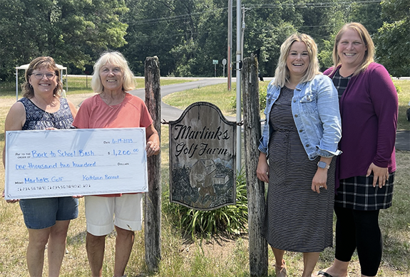 The check presentation to the Back to School Bash included Jan Novak – Back to School Bash Committee Member, Kathy Bennot – Marlinks Owner, Michele Heuer & Katie Peterson – Back to School Bash Committee members.