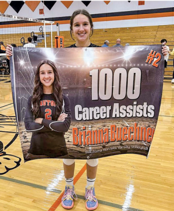 Wautoma Hornet, Brianna Buechner, proudly holds up her one-thousand assist banner after Sept. 19 matchup.