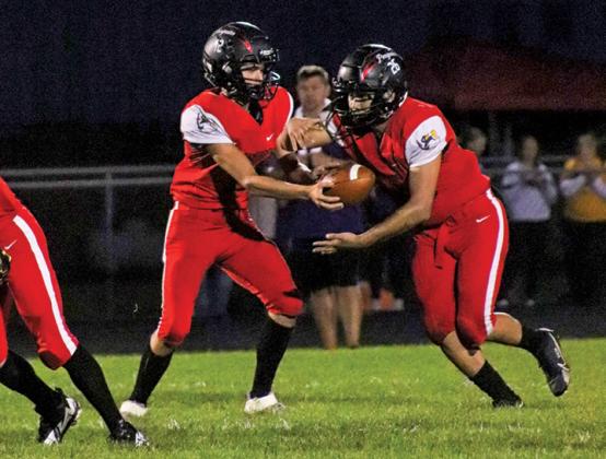 Tri-County Penguins Cayden Weis hands off the balll to Jovanni Mata during the first quarter of the Homecoming game on Sept. 22. 