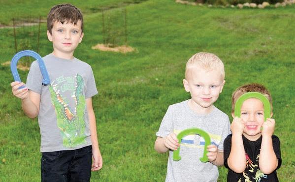 Jackson Rothe, 7, Wild Rose, Titus Tieman, 4, Poy Sippi, and McCoy Schenkenberger, 3, Saxeville, enjoyed a game of horse shoes.