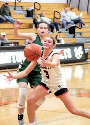 Senior Lady Hornet Montana Groskreutz saves the ball from going out of bounds against Colby. The Wautoma Lady Hornets hosted their two-day holiday tournament opening with an 85-58 win over Colby on Dec. 27.