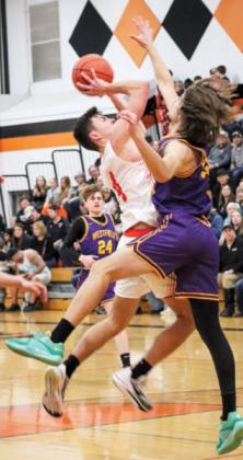 Senior Hornet Joseph Ascher takes a chance at 2-points while Pioneer’s Owen Hendee tries to block the shot. 